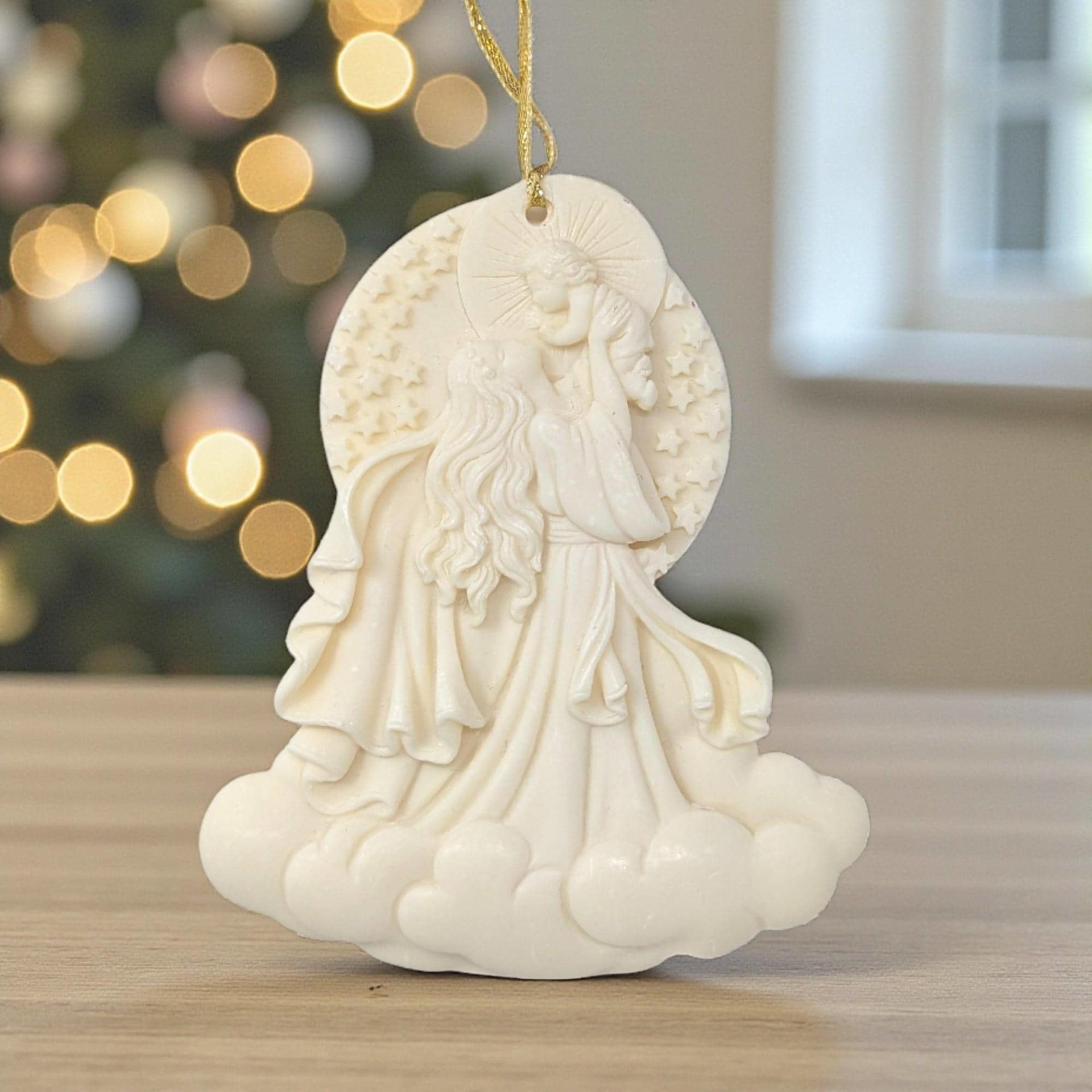 Cream-colored resin ornament featuring a relief carving of Mary holding the infant Jesus.
