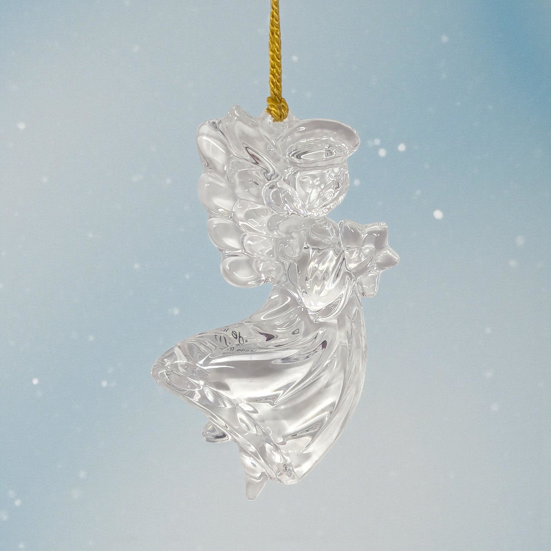 Clear faceted crystal angel ornament with a frosted face and hands. The angel has wide spread wings and a bell-shaped gown that catches and refracts light.