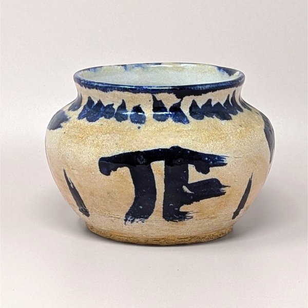 Handcrafted 1970s Senty studio pottery bowl featuring raw sand stoneware and bold cobalt blue abstract markings.
