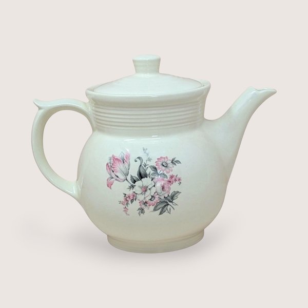 Vintage cream ceramic Drip-O-Lator coffee pot and lid. Features a central floral spray of pink tulips and white daisies. Sculptural scroll-top handle and tiered "stepping" on the neck. 7.25 inches tall.
