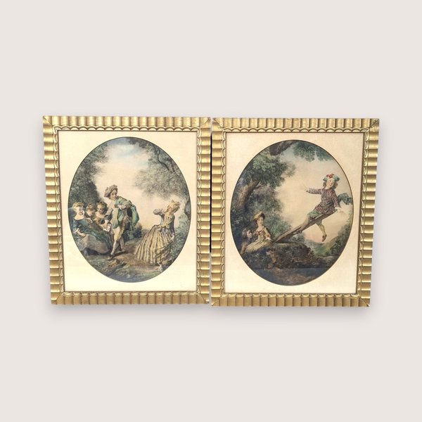 Set of two 1940s framed art prints by Nicolas Lancret titled "The Seesaw" and "Dropping the Handkerchief." Features pastoral Rococo scenes in ornate scalloped gold frames. 14.25 x 12.25 inches.