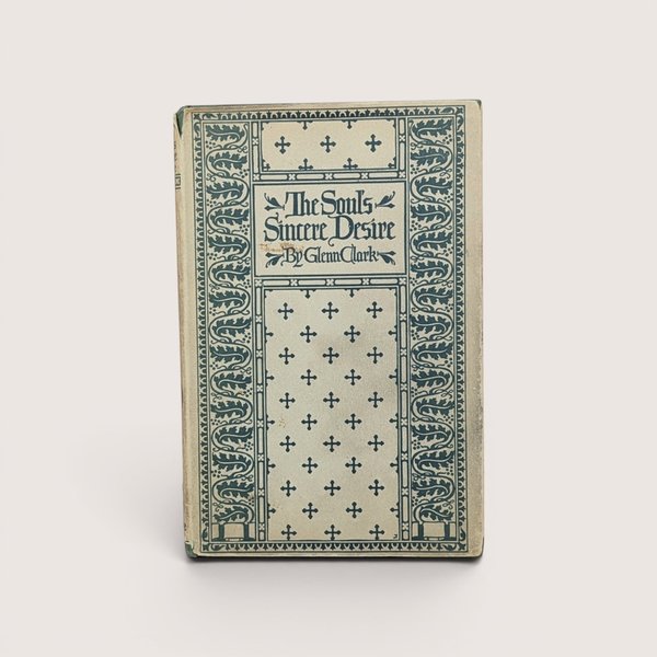 A vintage hardcover book with a cream and teal green patterned cover featuring crosses and floral borders, titled The Soul's Sincere Desire by Glenn Clark.