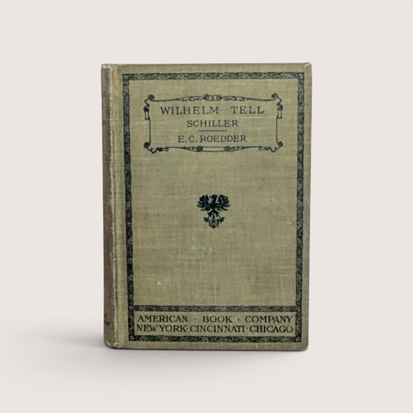 A 1905 hardcover copy of Wilhelm Tell by Schiller, featuring an olive green cloth cover with black ornamental borders and a central heraldic eagle crest.