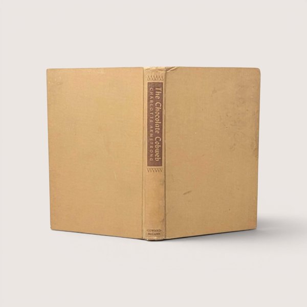 A vintage 1948 first edition hardcover of The Chocolate Cobweb by Charlotte Armstrong with a tan cloth cover and brown spine labelsA vintage 1948 first edition hardcover of The Chocolate Cobweb by Charlotte Armstrong with a tan cloth cover and brown spine labels