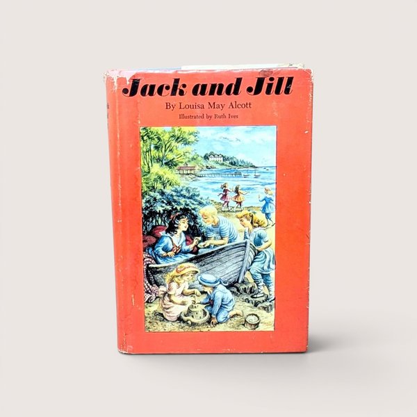 A vintage 1956 hardcover edition of Jack and Jill by Louisa May Alcott with a bright red dust jacket featuring children playing at the beach