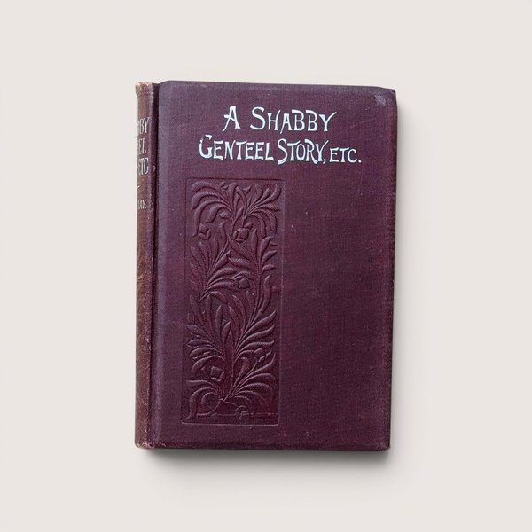 An antique burgundy book titled "A Shabby Genteel Story, Etc." with an embossed floral pattern on a beige background.