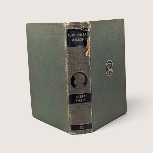 Antique 1922 green cloth hardcover book Pudd'nhead Wilson by Mark Twain with spine damage.
