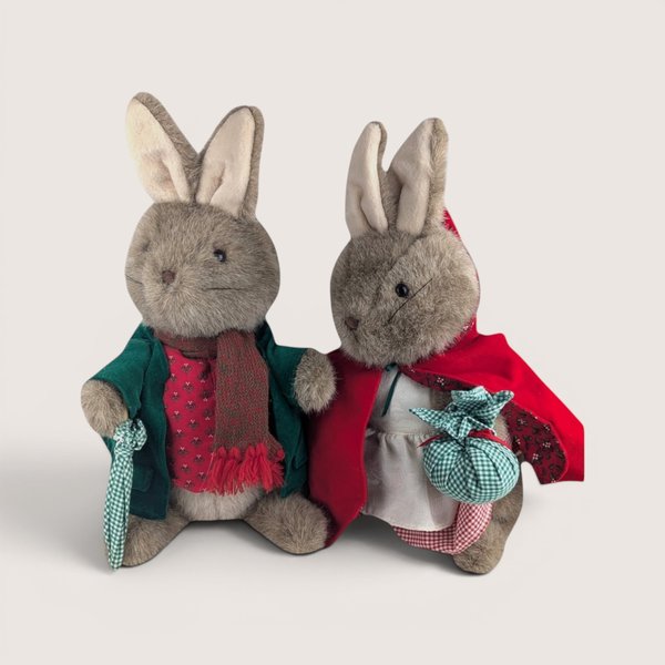 Two vintage Eden Toys Peter Rabbit and Mrs. Rabbit plush bunnies dressed in detailed fabric outfits side by side.