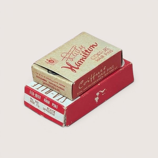 Two small vintage red and cream cardboard boxes for Sta-Rite and Lady Hamilton brand coiffure hair pins.