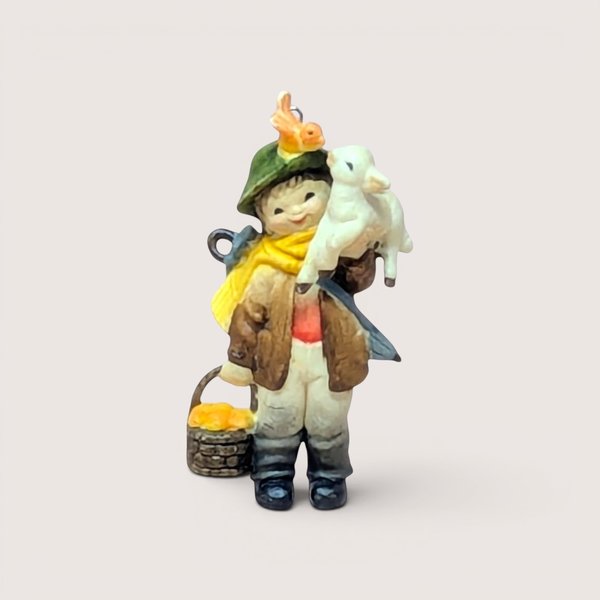 Anri Ferrandiz style miniature ornament of a young boy holding a white lamb with a bird on his hat