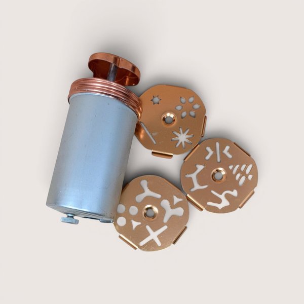 Vintage Mirro Dial-A-Cookie aluminum press cylinder with three copper-colored multi-design rotating discs.