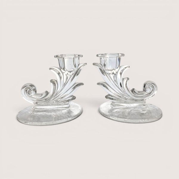 Pair of vintage Fostoria clear glass cornucopia scroll candlestick holders with delicate floral etching on the bases.