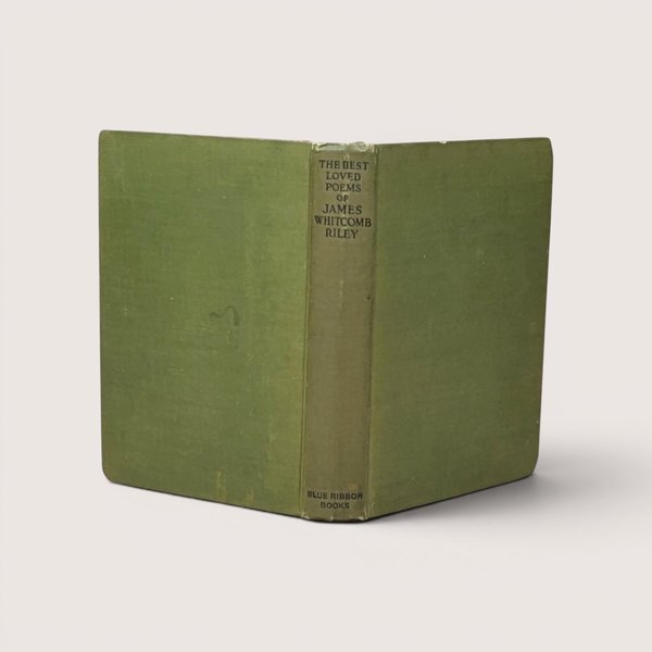 A vintage green cloth hardcover book spine and boards standing upright against a neutral backdrop