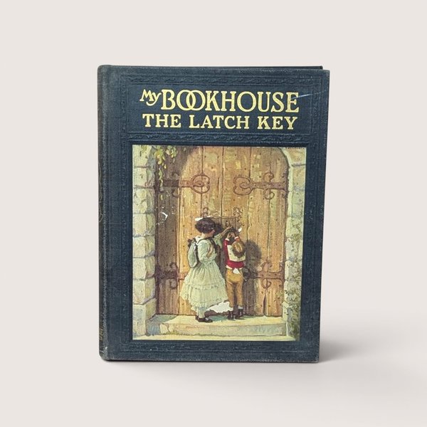 An antique black cloth hardcover book with gold text and a colorful illustration of two children at a large wooden door