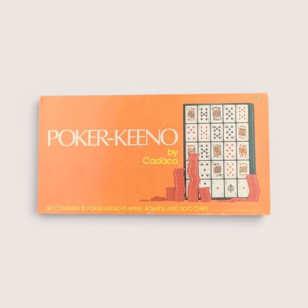 Vintage orange 1977 Cadaco Poker-Keeno board game box with stacks of red chips against a plain background.
