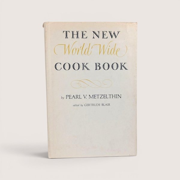 The New World Wide Cook Book 1939 vintage hardcover by Pearl V. Metzelthin with gold and black typography.