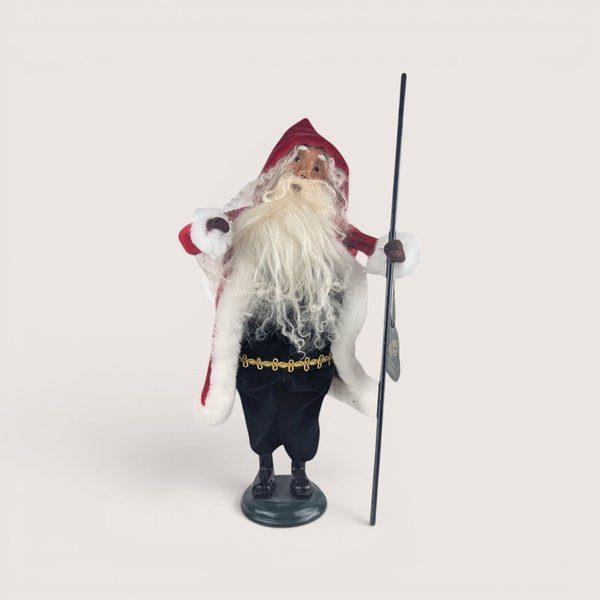 Byers Choice Victorian Santa caroler figurine in a red hooded coat holding a long black staff.