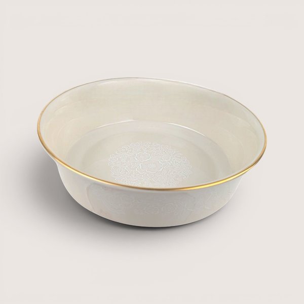 Vintage 1980s Lenox cream porcelain floral lace bowl with gold rim on neutral background.