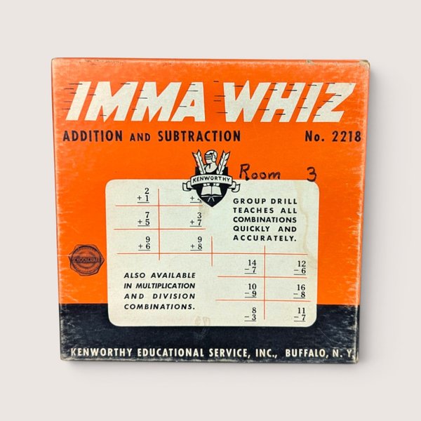 The orange and black box cover of a vintage Kenworthy Imma Whiz addition and subtraction math game featuring text, a knight crest logo, and sample problem grids.