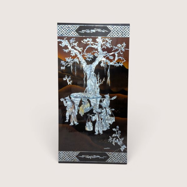 A large rectangular black lacquer wall panel featuring a detailed mother of pearl inlay scene under a large tree.