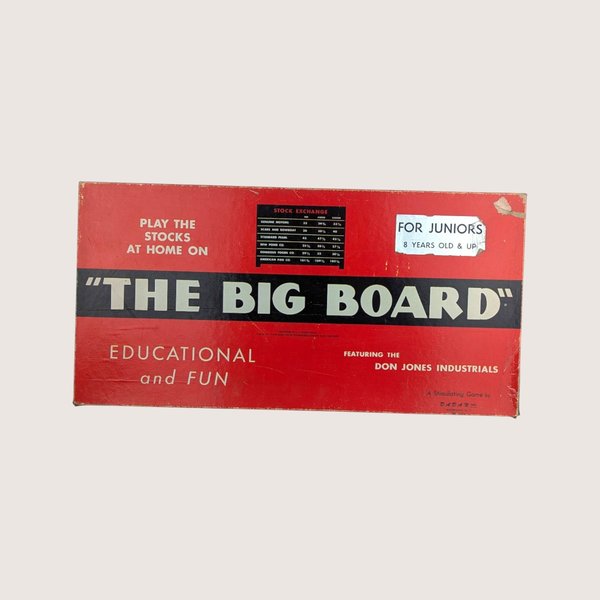 The vintage red and black box for The Big Board stock exchange game against a light background