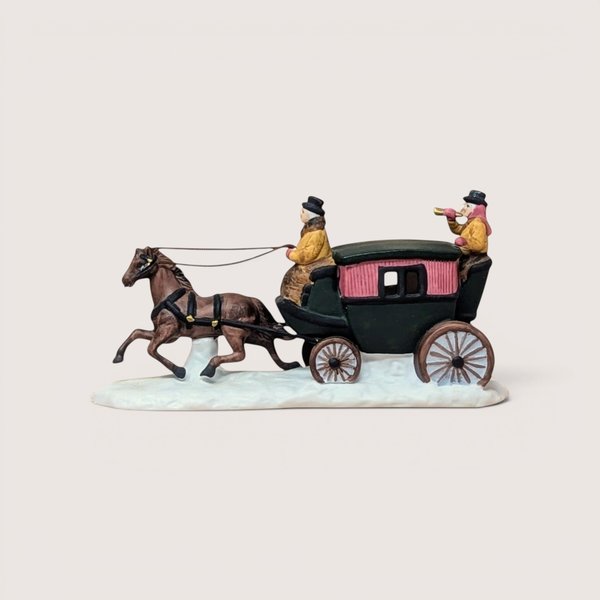 A vintage 1990 Department 56 Heritage Village Dover Coach figurine on a soft pink background. The hand painted porcelain sculpture features a trotting brown horse pulling a green and pink carriage with figures over a snow covered base.