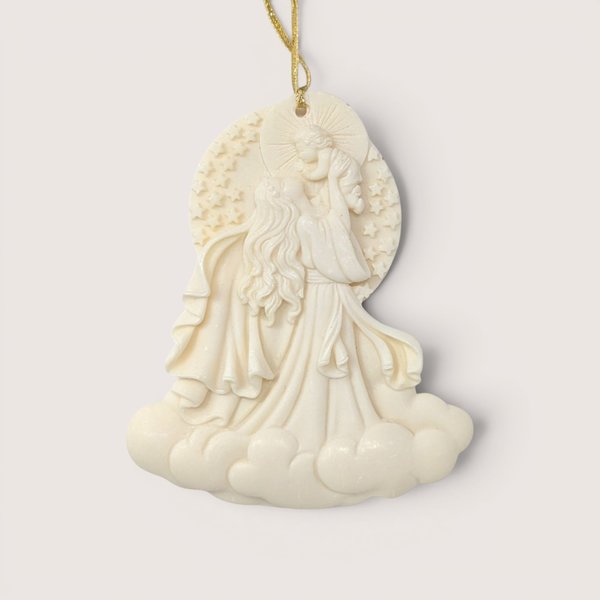 A 2000 Roman Inc "Cause of Our Joy" Millennium Series ornament on a soft pink background. The cream-colored resin cameo style sculpture depicts a flowing Madonna figure raising the infant Christ child into the sky above a base of billowy clouds.