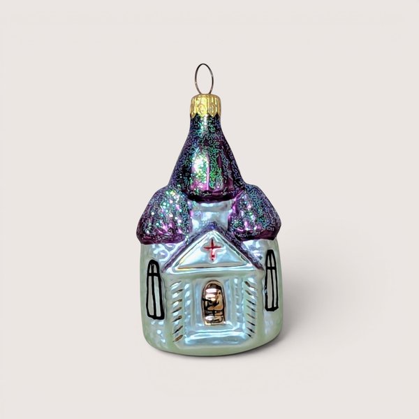Hand painted iridescent glass Christopher Radko Christmas ornament shaped like a church with glittery purple roofs.