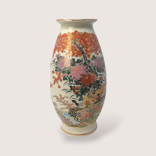 Tall Japanese porcelain vase featuring a detailed colorful pheasant bird amidst chrysanthemums and trees.