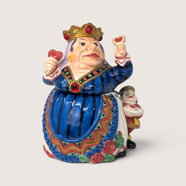Ceramic Queen of Hearts cookie jar from Alice in Wonderland holding heart scepters on a solid background.