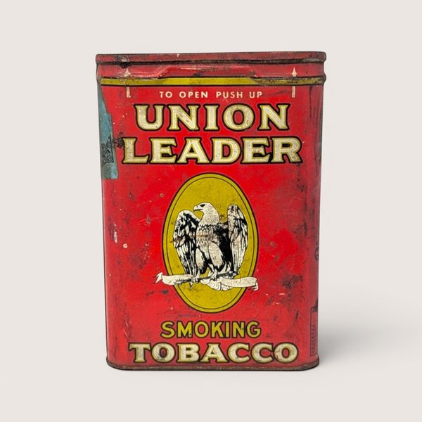 Vintage red Union Leader empty pocket tobacco tin featuring a yellow oval with a white eagle logo.