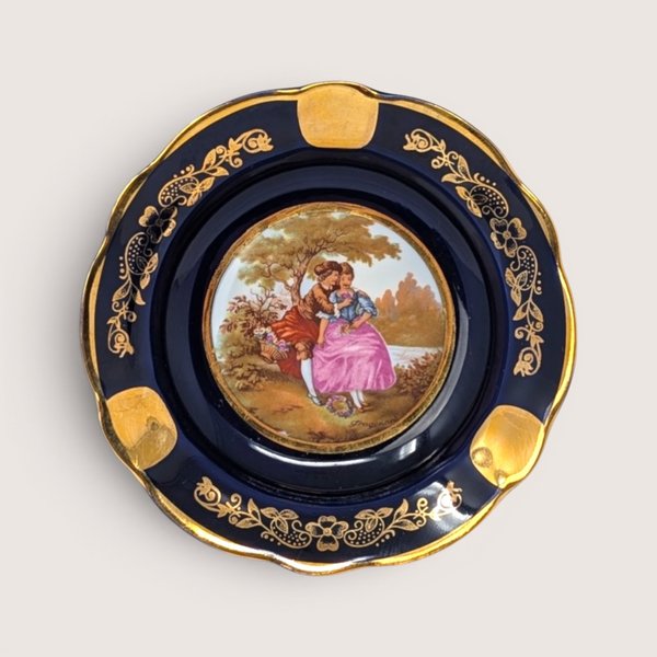Vintage Limoges cobalt blue porcelain ashtray with a gold-gilded border and a center Fragonard courting couple scene.