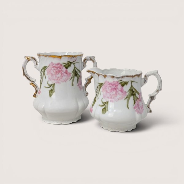 Antique Royal Bavarian PM porcelain sugar bowl and creamer set with pink floral designs and gold accents.