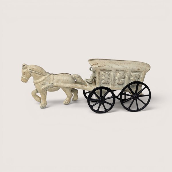 Vintage cream-colored cast iron horse pulling a toy ice wagon cart with a removable driver figure.