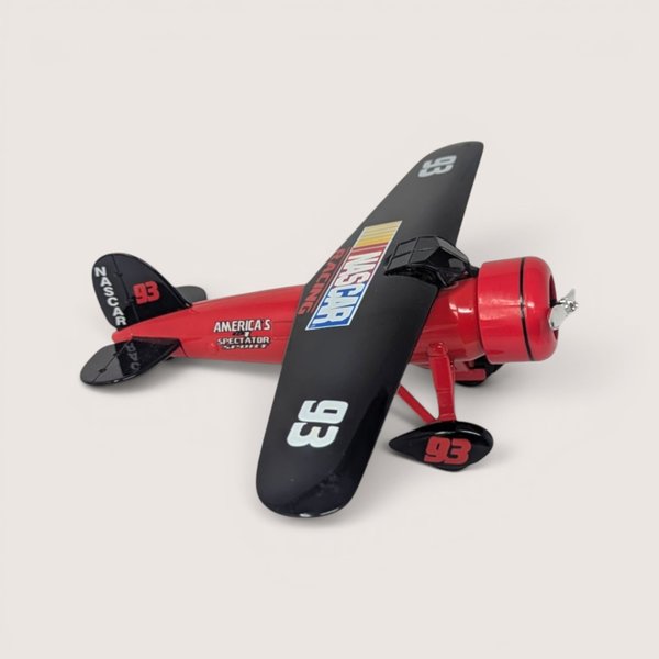 Vintage 1990s Ertl NASCAR Travel Air Model R Mystery Ship die-cast airplane coin bank in red and black livery with box.