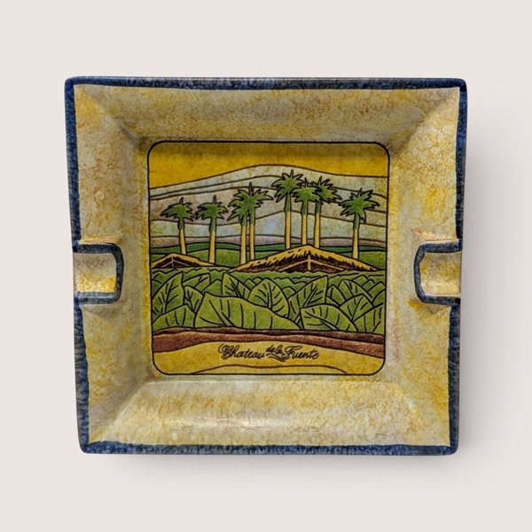 Square hand painted ceramic ashtray featuring a tobacco field with palm trees and Chateau de la Fuente script.