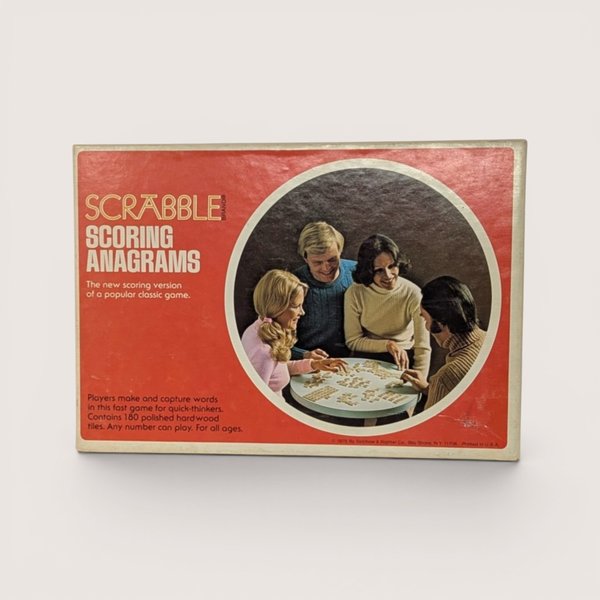 Vintage 1975 Scrabble Scoring Anagrams game box in red with a circular photo of four people playing at a table.