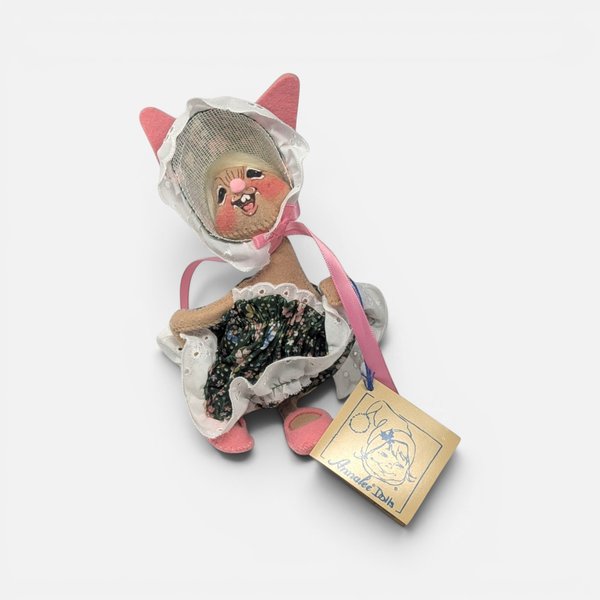 Vintage 1998 Annalee felt Easter parade girl doll wearing a lace bonnet and a floral dress.
