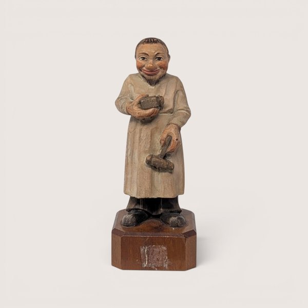 Vintage 1950s Anri Toriart hand-carved wooden apothecary figurine holding medical tools on an octagonal base.