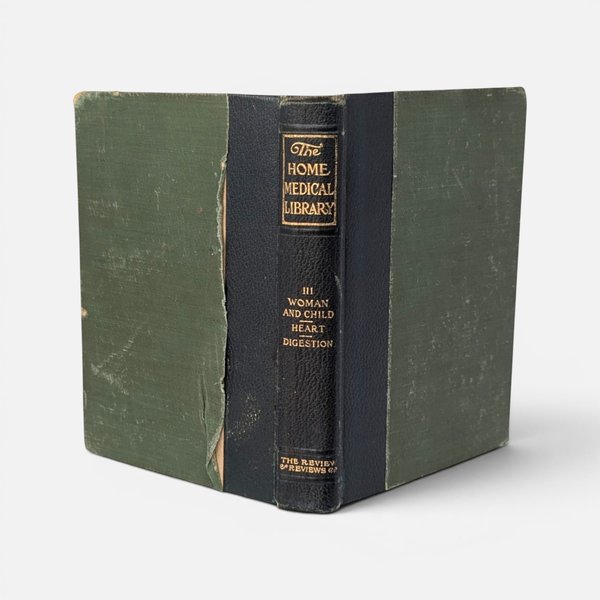 Vintage 1907 hardcover copy of The Home Medical Library with a dark spine and green covers.