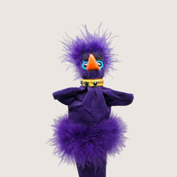 Vintage handmade felt and feather bird stick puppet in vibrant purple with an orange beak and jeweled collar.