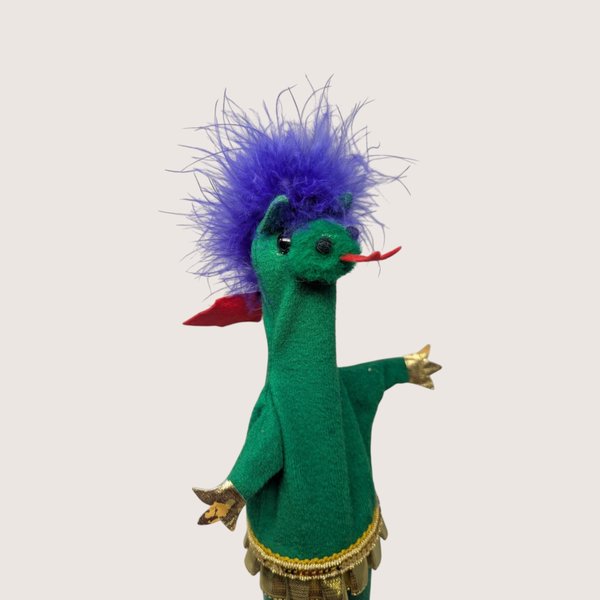 Vintage handmade felt dragon puppet in green with a purple feather mane, red tongue, and gold trim.