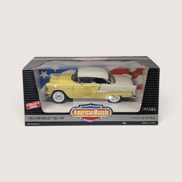 Vintage 1995 Ertl American Muscle yellow and white 1955 Chevrolet Bel Air die-cast vehicle in its original window box set against a plain linen background.