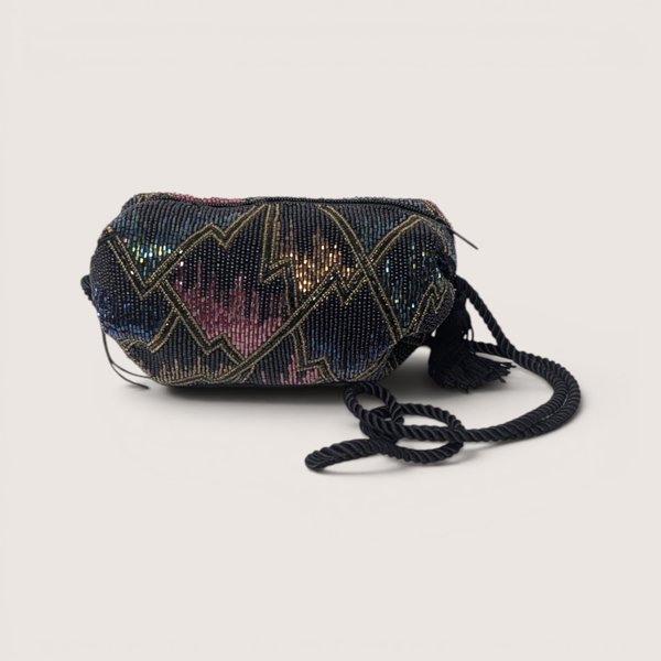 Vintage black evening purse covered in sparkling multicolor seed beads with a black cord strap