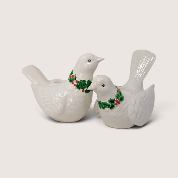 Pair of vintage Fitz and Floyd white ceramic dove candle holders with green holly wreaths and red berries.
