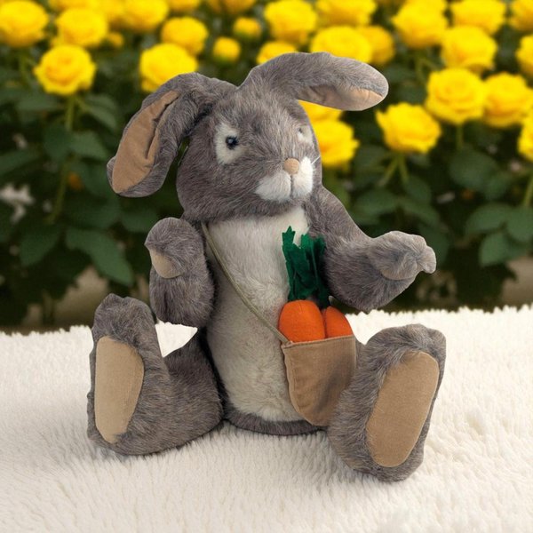 A soft, tan-colored plush rabbit in a sitting pose with large, upright ears. The rabbit features a white underbelly and white inner ears, with a small pink stitched nose and dark, glossy safety eyes. The plush has a dense, slightly shaggy texture typical of early 1980s Dakin toys.