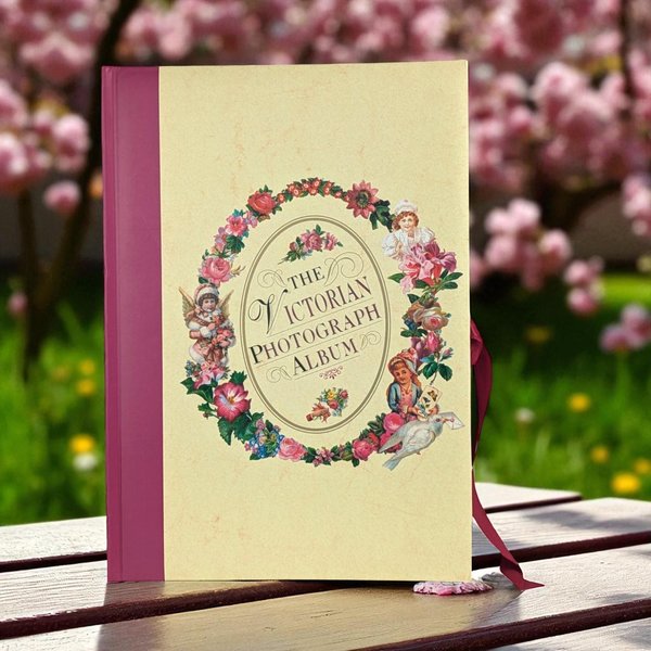 A rectangular photograph album with a romantic Victorian-inspired cover design featuring ornate floral motifs and lace-like borders. The album has a sturdy hardcover with a matte finish.