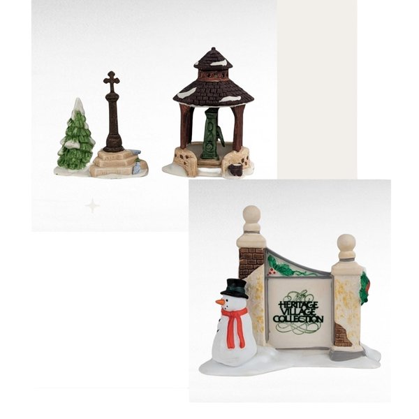 Three hand-painted porcelain miniatures featuring a winter village theme. The set includes a tall stone cross beside a snow-dusted evergreen, a brown-roofed village well house, and a stone gate featuring a snowman in a black top hat and red scarf.