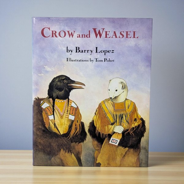 A hardcover book titled Crow and Weasel with a matte dust jacket. The illustration features a crow and a weasel in traditional Indigenous buckskin clothing with fringe and beadwork against a watercolor lavender sky.