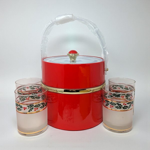 A sparkling glass ice bucket and matching tumblers featuring a bold red and 22K gold geometric pattern. The glassware has a high-gloss finish and is displayed alongside its original vintage packaging, showing a pristine, reflective surface.